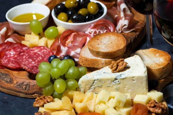 a plate of food with a glass of wine