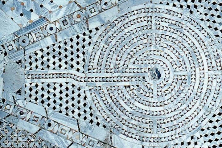 Intricate circular mosaic pattern with geometric designs and labyrinth motif.